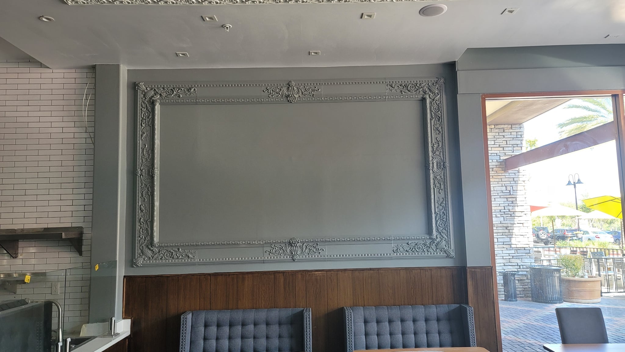Modern interior with decorative wall molding and gray chairs.